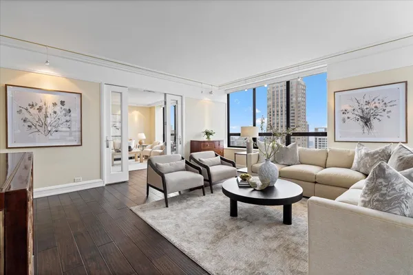a living room with furniture a rug and a window