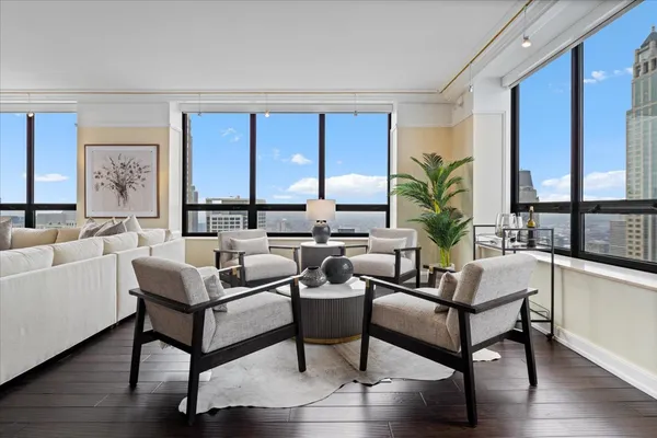 a living room with furniture and a potted plant