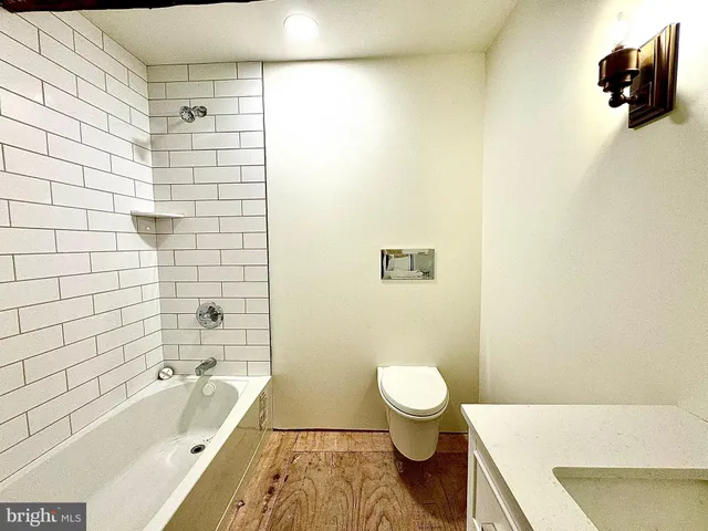 a view of house with a yard outdoor seating and covered with snow