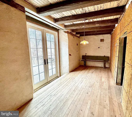 a view of a room with wooden floor and windows