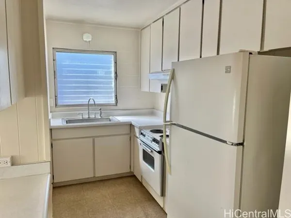 a kitchen with stainless steel appliances a refrigerator sink and cabinets