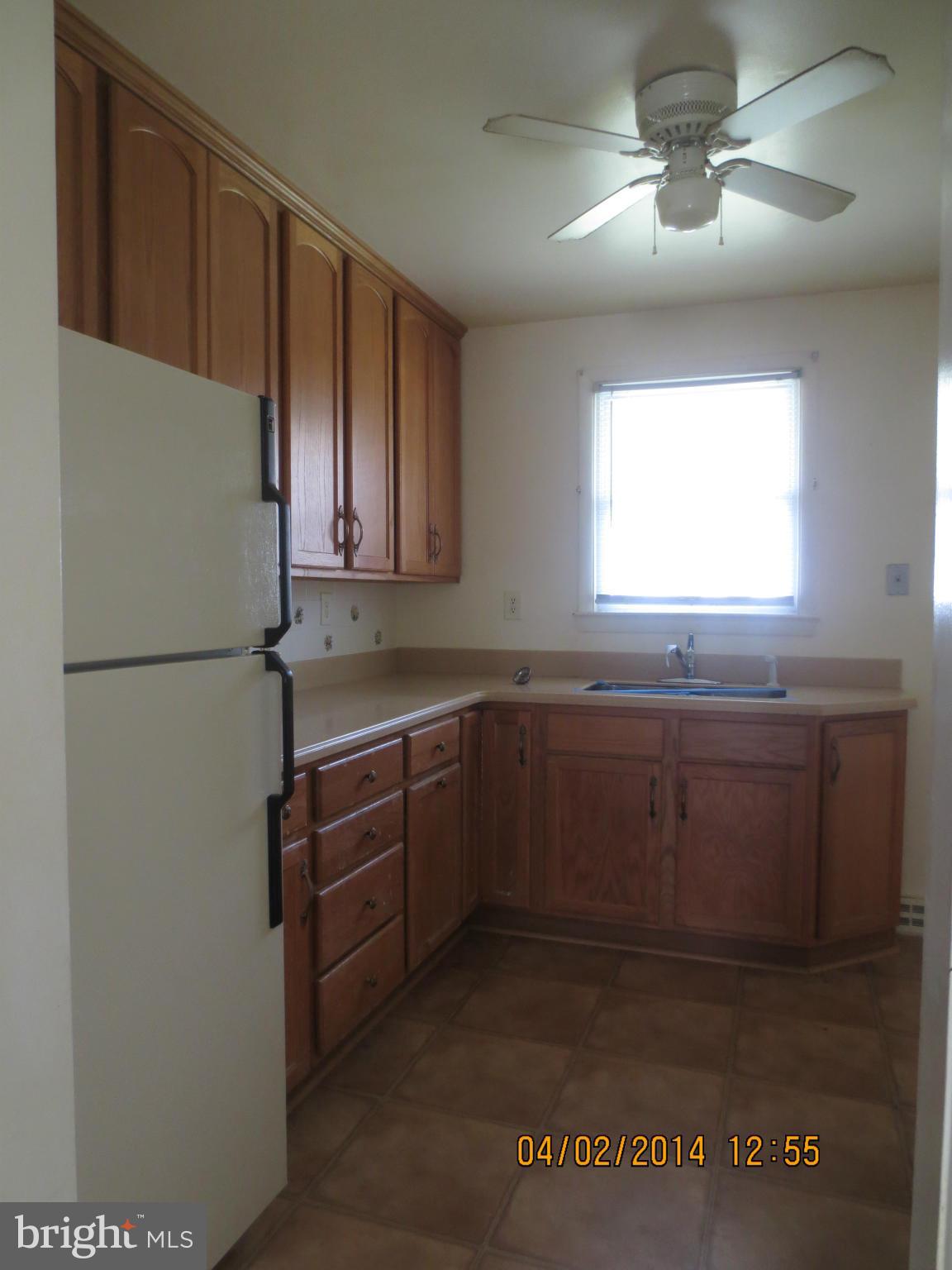 6796 Amherst Road Bryans Road, MD 20616 - Photo 3 of 10 a kitchen with granite countertop a refrigerator a sink and dishwasher