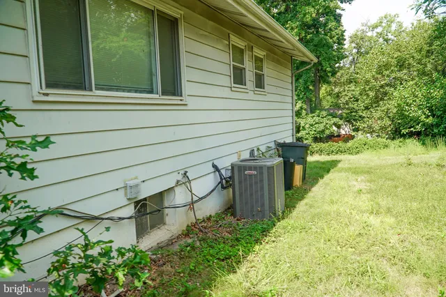 a yellow house with trees in front of it