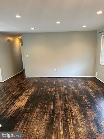 an empty room with wooden floor