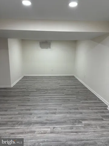 a view of an empty room and wooden floor