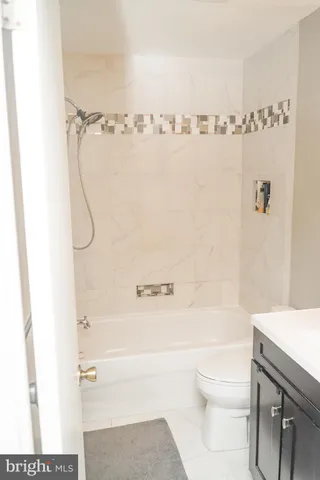 a bathroom with a shower a toilet and a sink