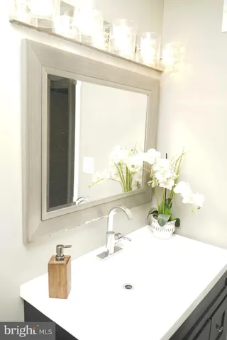 a bathroom with a sink vanity and a mirror