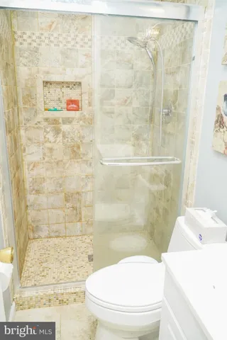 a bathroom with a toilet a sink and shower