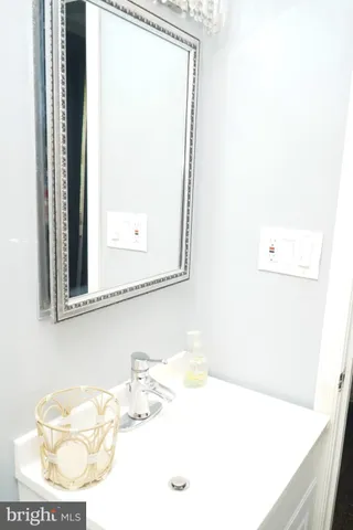 a bathroom with a sink a mirror and a vanity