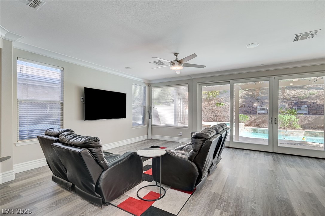 2391 Rainswept Avenue Henderson, NV 89052 - Photo 9 of 62 This bright living space features expansive glass doors, inviting natural light and serene outdoor views.