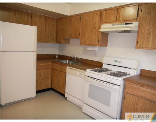 1938 Raspberry Court Edison, NJ 08817 - Photo 8 of 13 a kitchen with granite countertop white cabinets and white appliances