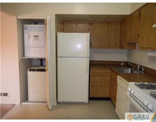1938 Raspberry Court Edison, NJ 08817 - Photo 10 of 13 a kitchen with a refrigerator sink stove and cabinets