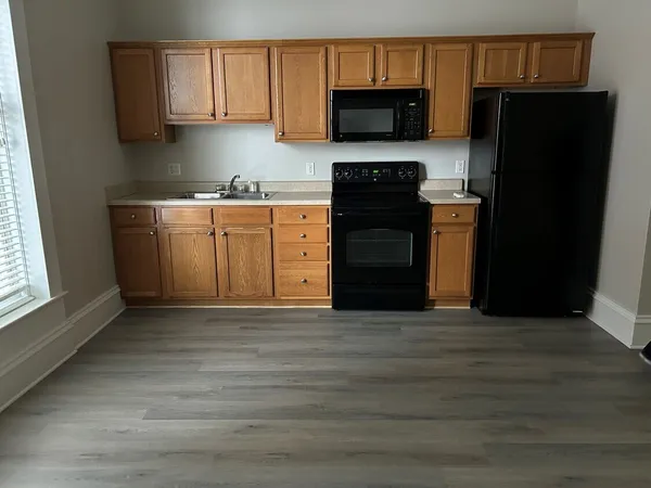 a kitchen with a sink and a refrigerator