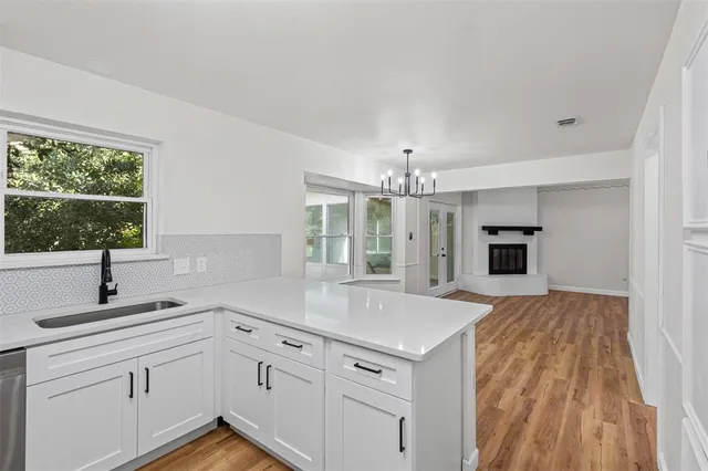 a kitchen with cabinets a sink and appliances