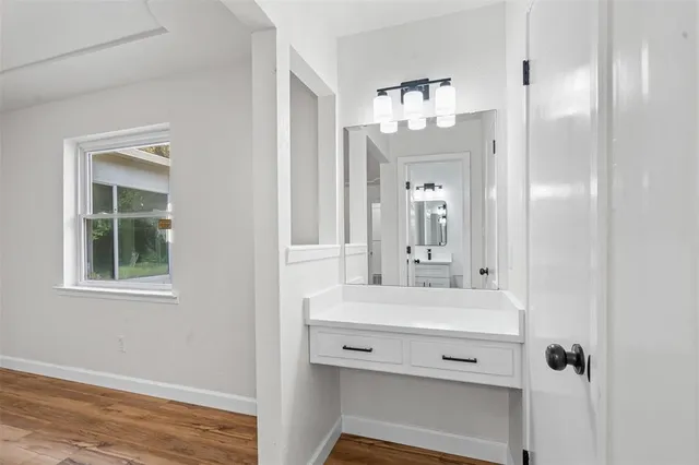 a bathroom with a sink vanity and a mirror