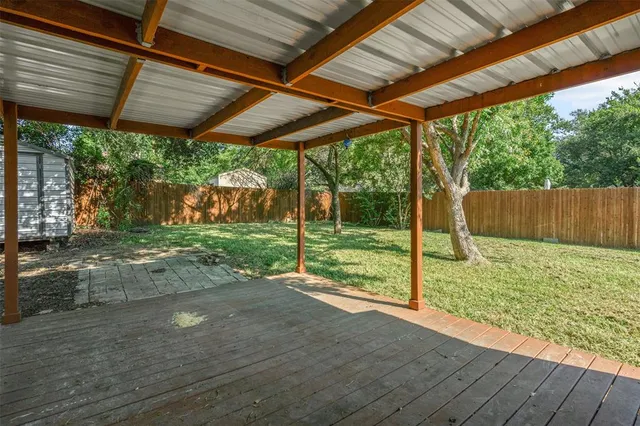 a backyard of a house with a garden and outdoor seating