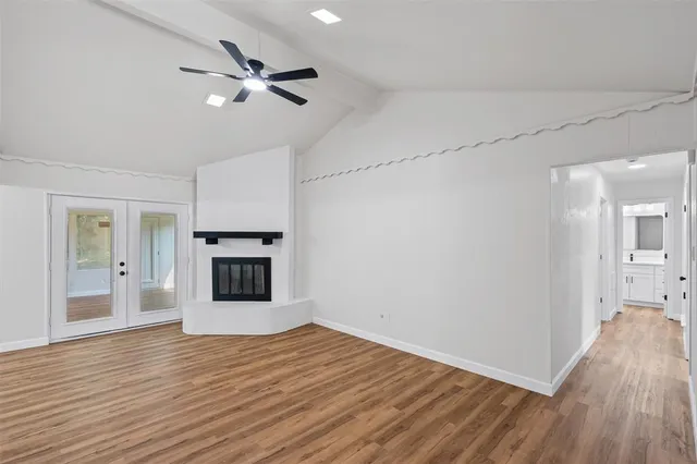 a view of a kitchen with wooden floor and a ceiling fan