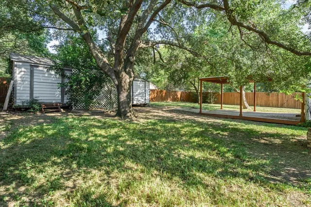 a view of a backyard with large trees