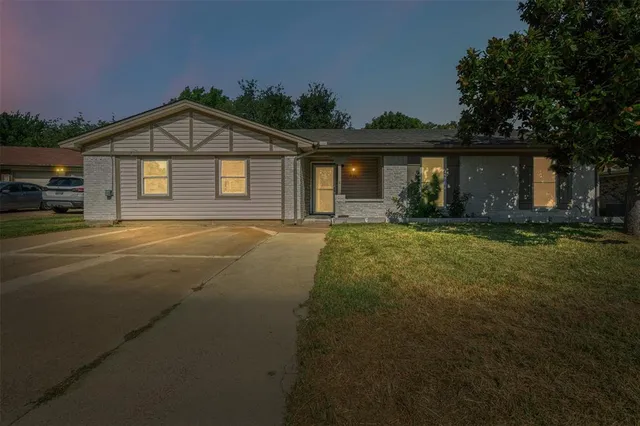 a front view of a house with yard and green space