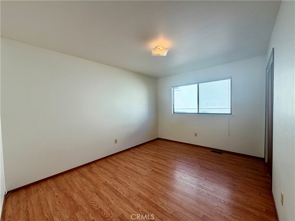 20764 Powder Horn Road Hidden Valley Lake, CA 95467 - Photo 14 of 27 an empty room with wooden floor and windows