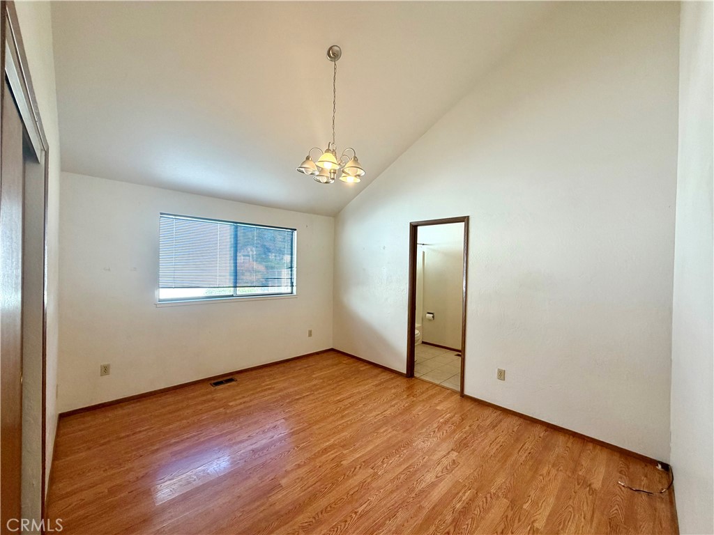 20764 Powder Horn Road Hidden Valley Lake, CA 95467 - Photo 19 of 27 a view of an empty room with window and wooden floor