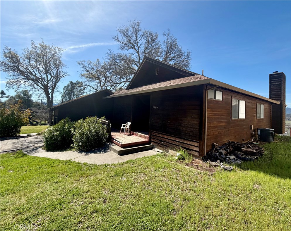 20764 Powder Horn Road Hidden Valley Lake, CA 95467 - Photo 25 of 27 a backyard of a house with table and chairs and iron fence