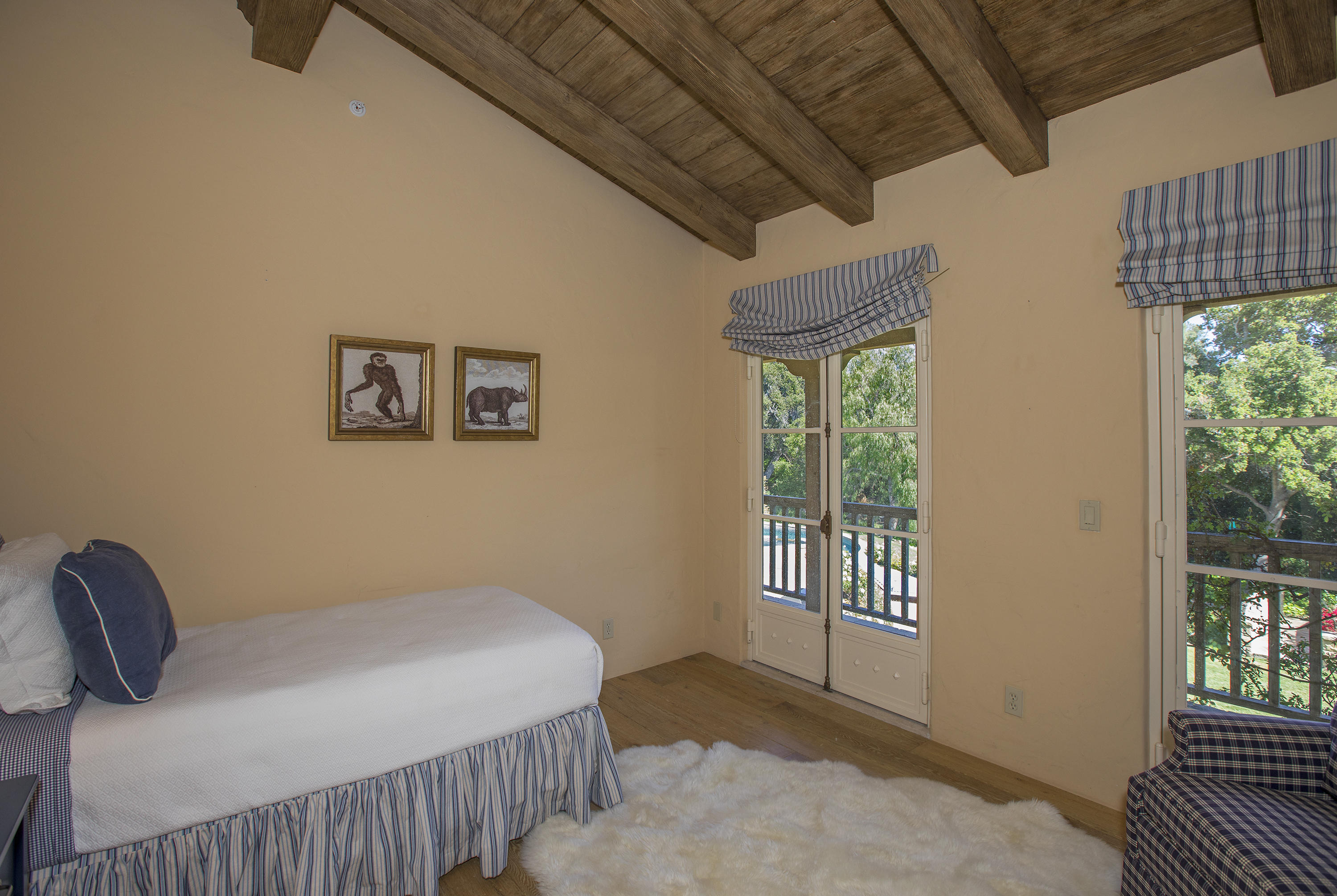 1525 Las Tunas Road Montecito, CA 93108 - Photo 16 of 28 a bedroom with a bed and wooden floor