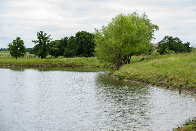 a view of a lake view with house in background