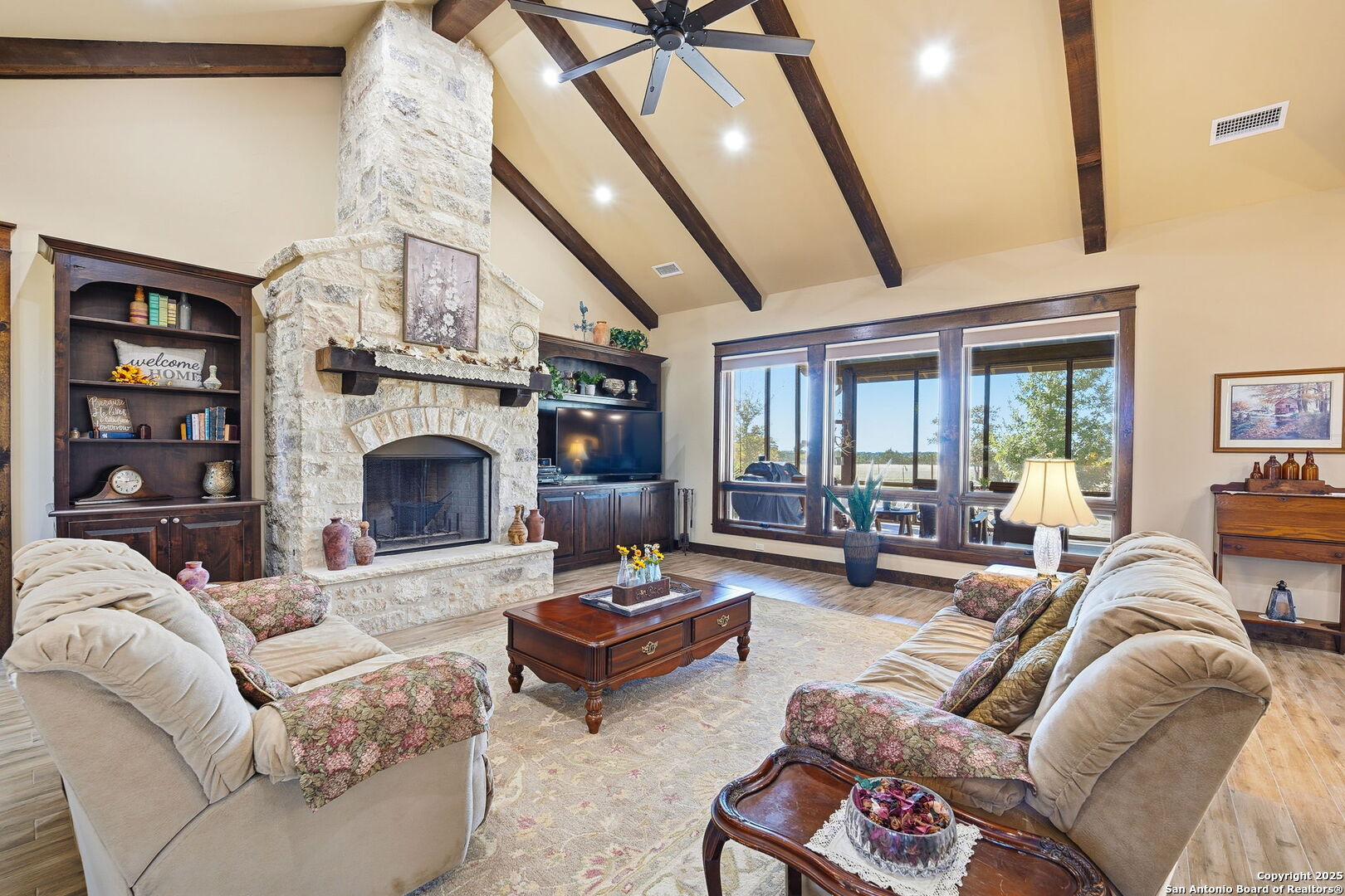 601 Garrison Road Fredericksburg, TX 78624 - Photo 11 of 77 a living room with furniture a fireplace and a large mirror