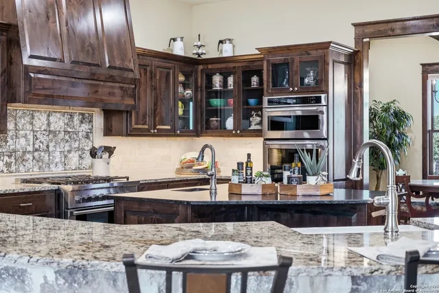 a large kitchen with a table and chairs