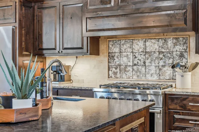 a stove top oven sitting inside of a kitchen