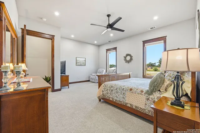 a bathroom with a granite countertop sink a toilet and a mirror