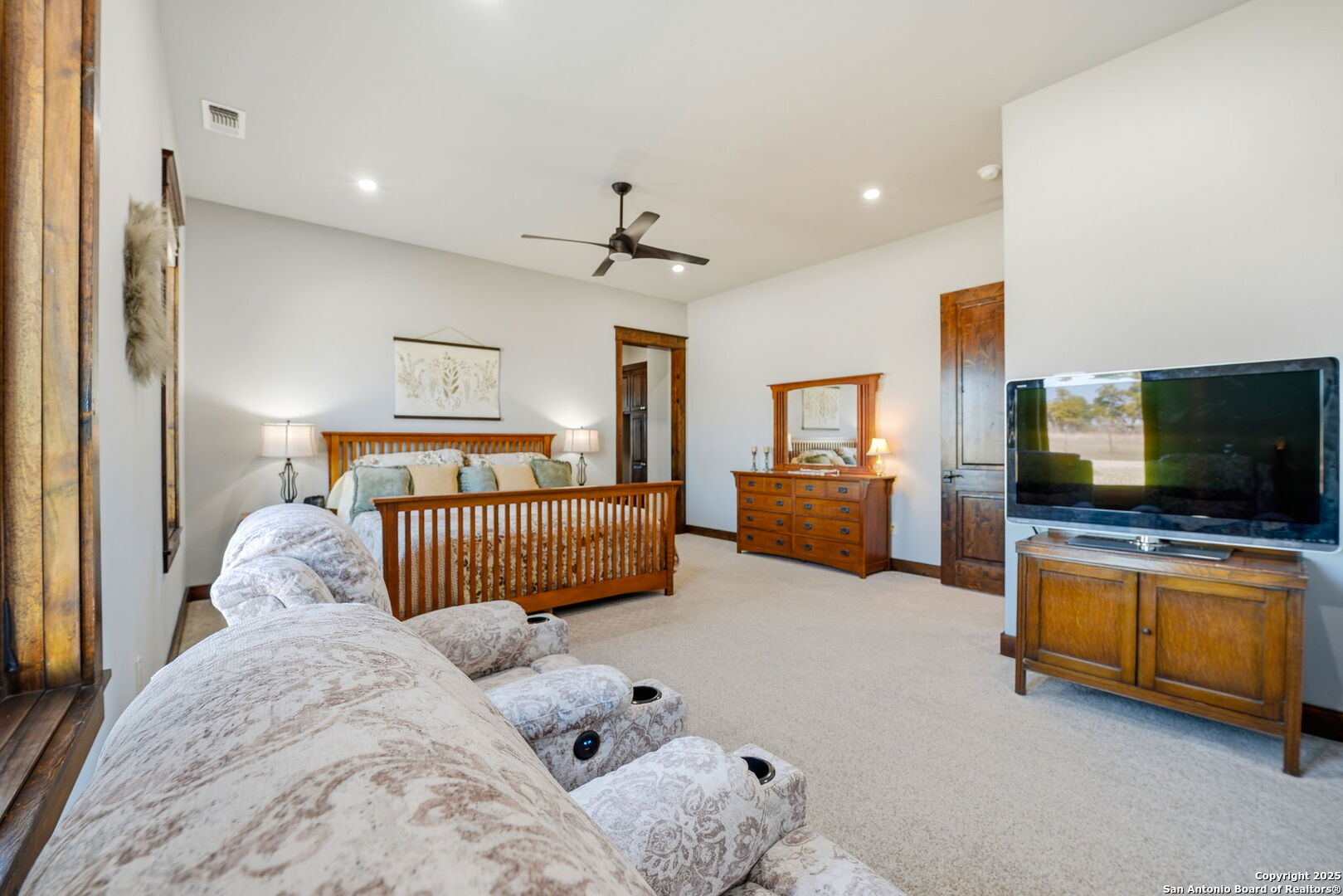 601 Garrison Road Fredericksburg, TX 78624 - Photo 26 of 77 a bedroom with furniture and flat screen tv