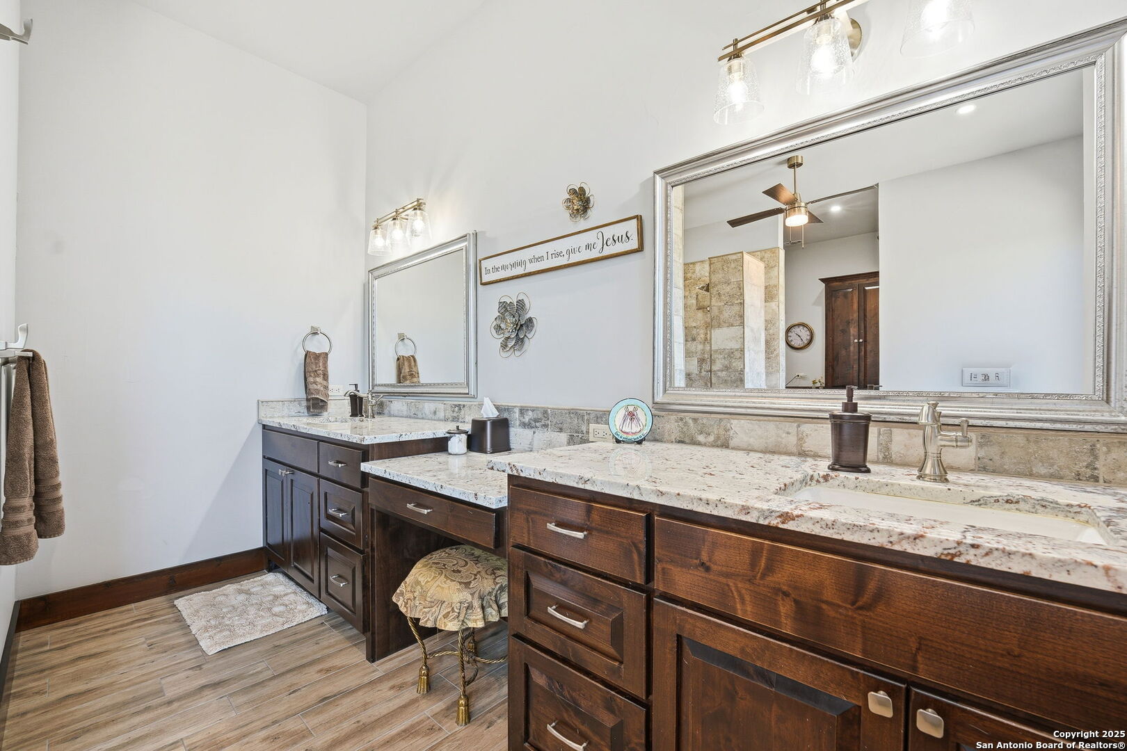 601 Garrison Road Fredericksburg, TX 78624 - Photo 28 of 77 a bathroom with a granite countertop sink a toilet and a mirror