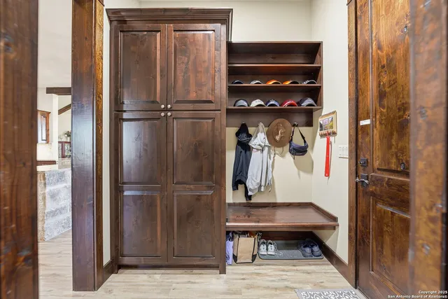 a view of a backyard with couches plants and large tree