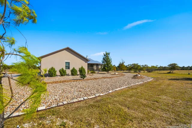 an aerial view of a house with yard swimming pool and outdoor seating