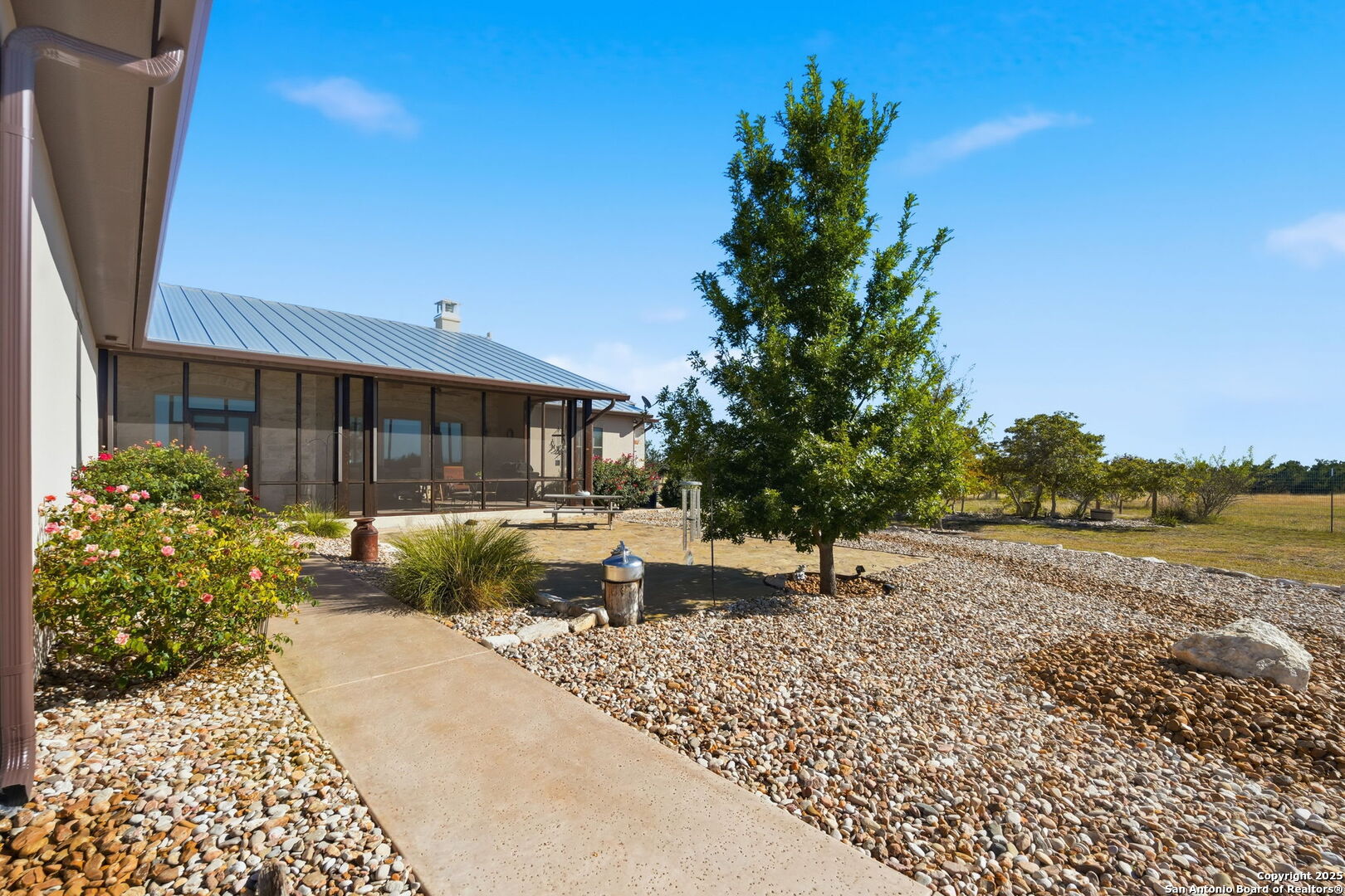 601 Garrison Road Fredericksburg, TX 78624 - Photo 57 of 77 a view of a backyard with couches plants and large tree