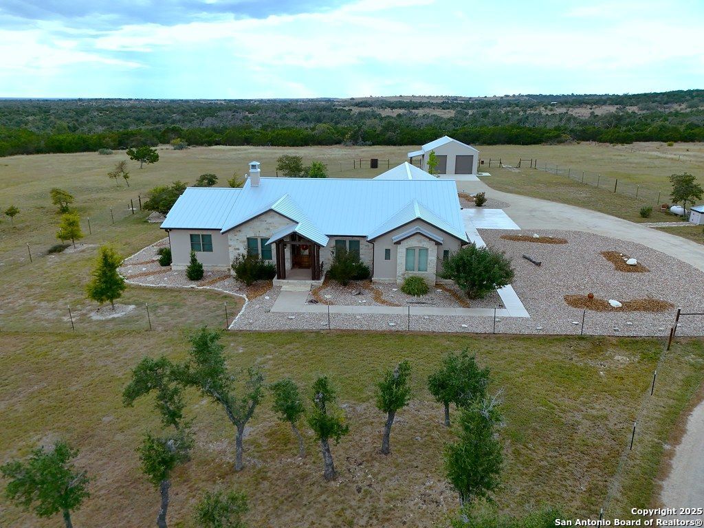 601 Garrison Road Fredericksburg, TX 78624 - Photo 67 of 77 a aerial view of a house with pool lake view and mountain view