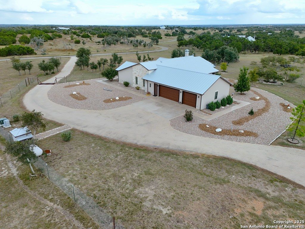 601 Garrison Road Fredericksburg, TX 78624 - Photo 72 of 77 an aerial view of a house with a yard