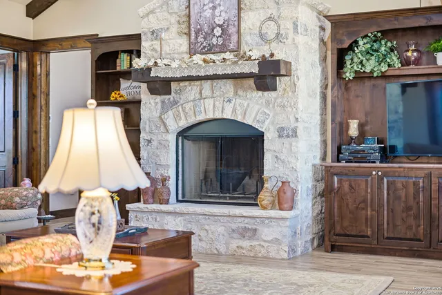 a living room with furniture a fireplace and a table