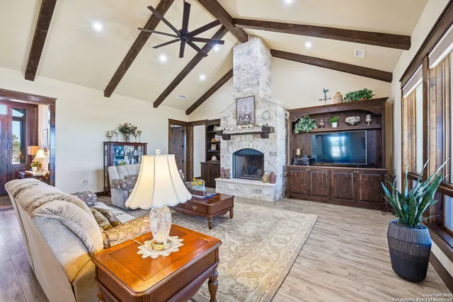 a living room with furniture a fireplace and a large mirror