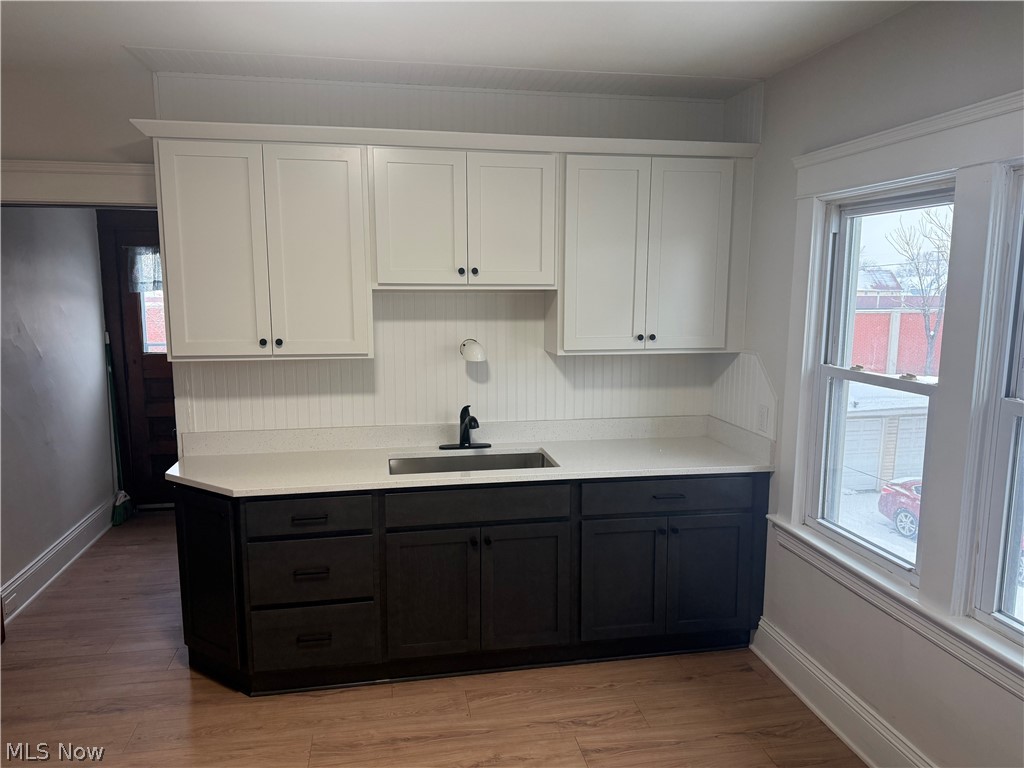 3612 Riverside Avenue Cleveland, OH 44109 - Photo 3 of 22 Kitchenette featuring two-tone cabinetry with upper white shaker-style doors and lower dark wood-finish cabinetry