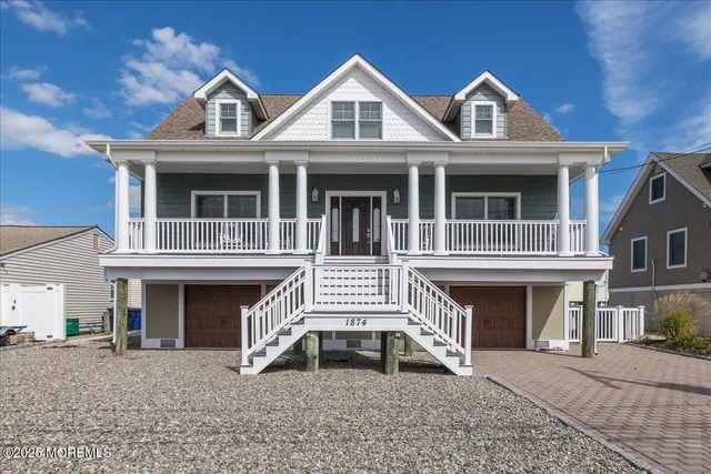 a front view of a house with a yard and balcony