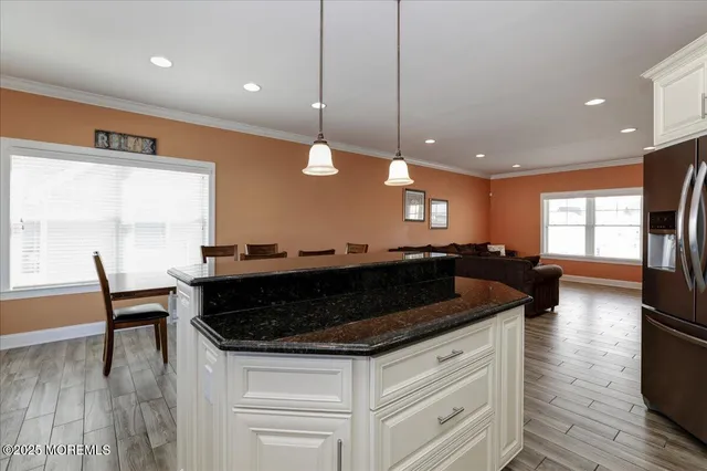 a view of kitchen with cabinets table and chairs