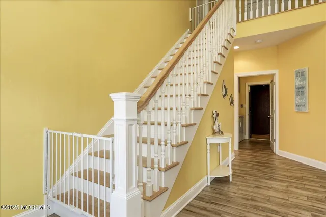 a view of entryway and hall with wooden floor