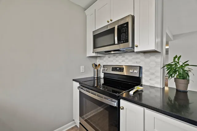 a kitchen with a stove and a microwave