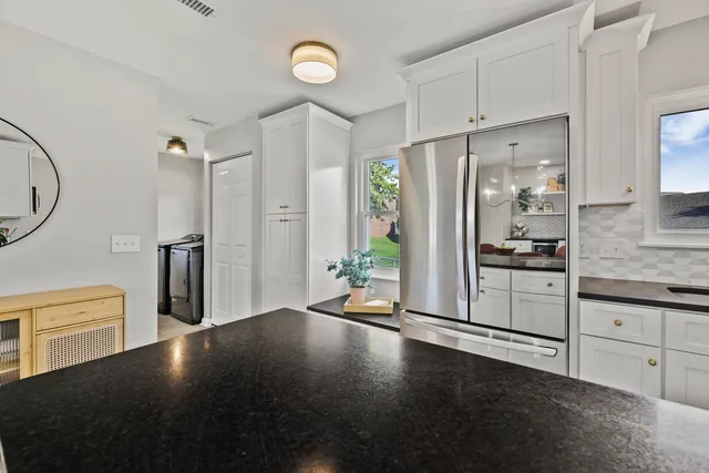 a kitchen with stainless steel appliances a refrigerator and a stove top oven