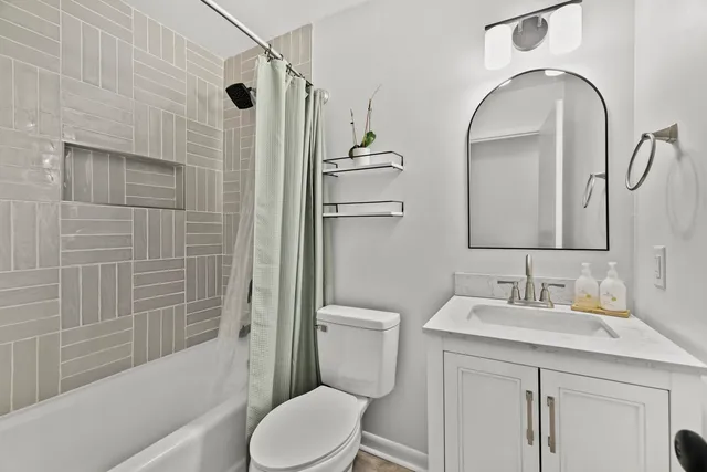 a bathroom with a toilet sink and shower