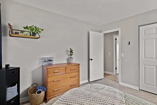 a bedroom with a bed and a dresser