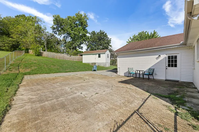 a view of backyard of house with green space